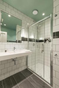 a bathroom with a shower and a sink at Wynn's Hotel in Dublin