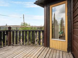 a wooden deck with a sliding glass door at Chalet Korpstigen Renen by Interhome in Sälen +16 photos