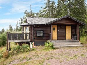 a log cabin with a porch and a deck at Chalet Korpstigen Renen by Interhome in Sälen