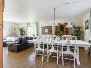 a living room with a white dining room table and chairs at Holiday Home Ryedal by Interhome in Svängsta +27 photos