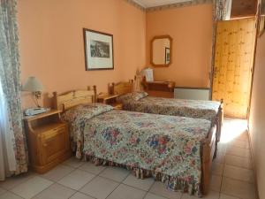 a hotel room with two beds and a mirror at Hotel Lion in Roure Turin