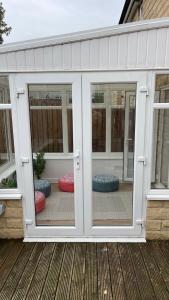 an open patio door on a house with windows at Supreme Apartments in Keighley