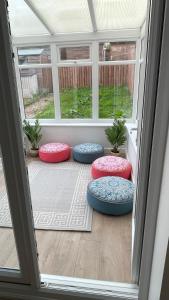 a group of four pillows sitting on a porch at Supreme Apartments in Keighley