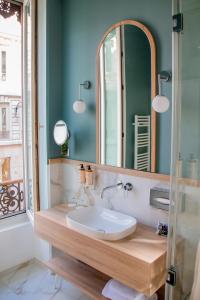 a bathroom with a sink and a mirror at Mercure Lyon Centre Beaux-Arts in Lyon