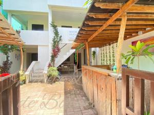 a house with a wooden fence and a staircase at WHITEBEACH DE BORACAY STATION 1 (EXTENSION) in Boracay