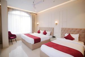 Postel nebo postele na pokoji v ubytování Hotel Green Land Heights