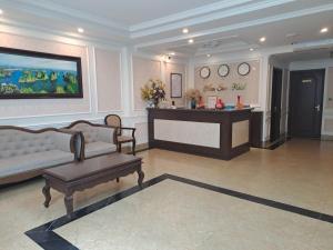 a living room with a couch and a table at NAM SON HOTEL in Ha Long