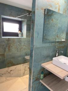 a bathroom with a sink and a glass shower at Fam de Vida in Gratallops