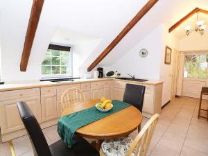a kitchen and dining room with a wooden table at Loft apartment in Llandysul