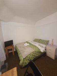 a small bedroom with a bed and a night stand at HESFORD (A) in Manchester