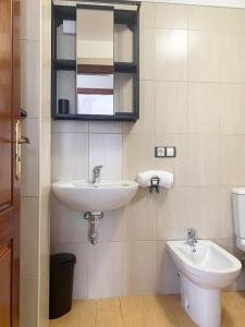 a bathroom with a sink and a toilet and a mirror at Moon House in La Victoria de Acentejo