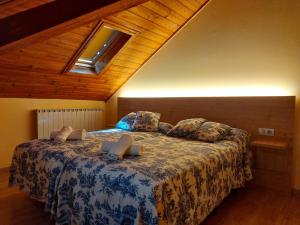 a bedroom with a large bed with a wooden ceiling at Hotel Saurat in Espot