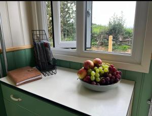 a bowl of fruit on a counter next to a window at Ted's Shed in Bishop Auckland