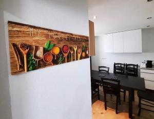 a kitchen and dining room with a painting on the wall at home2stay worker house Nürtingen HS29 in Nürtingen
