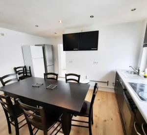 a dining room with a black table and chairs at home2stay worker house Nürtingen HS29 in Nürtingen