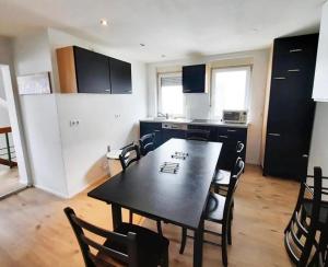 a kitchen with a table and chairs in a room at home2stay worker house Nürtingen HS29 in Nürtingen