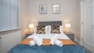 a bedroom with a large bed with white pillows at Luxury 1 BDR City Apartments by Belfast City Breaks in Belfast