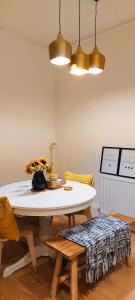 a dining room with a table and two lights at A home away from home in Torquay