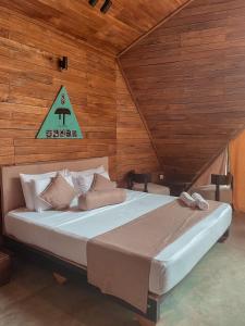 a bedroom with a large bed with a sign on the wall at Gabaa Resort & Spa - Habarana in Habarana