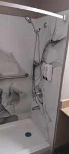 a shower in a room with a broken wall at Red Roof Inn Huntsville, AL in Huntsville