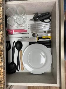 a cabinet with a plate and utensils in it at Apartamento en Barrio Sur DOS HABITACIONES in Montevideo