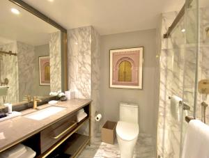 a bathroom with a sink and a toilet and a shower at SAHARA Las Vegas in Las Vegas