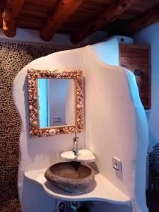 a bathroom with a sink and a mirror at Appartamento incantevole in centro Es Pujols in Es Pujols