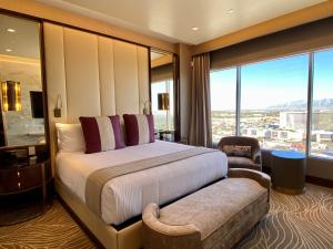 a hotel room with a bed and a large window at SAHARA Las Vegas in Las Vegas