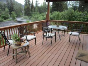 a deck with two tables and chairs on it at SEWARD APARTMENT in Seward