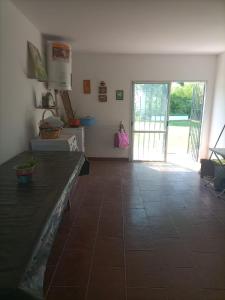 a kitchen with a tile floor and a door to a yard at CASA RUBIA MORENO in La Banda