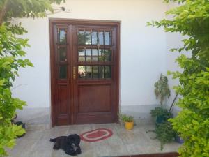 a black dog laying in front of a door at CASA RUBIA MORENO in La Banda