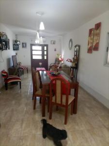 a cat sitting on the floor in a living room at CASA RUBIA MORENO in La Banda