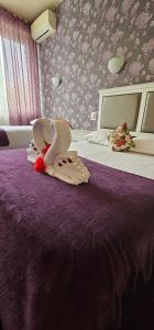 Voodi või voodid majutusasutuse Hotel Olimp toas