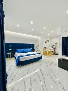 a bedroom with a blue bed and a living room at Oltremare in Bari