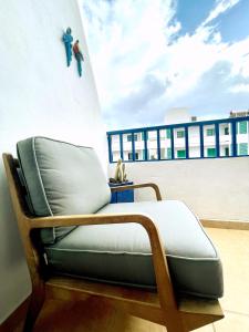 a chair sitting on the side of a building at Casita Mara! 2’ Line to the sea, shops and bar’s in Puerto del Carmen