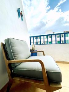 a chair sitting on the side of a building at Casita Mara! 2’ Line to the sea, shops and bar’s in Tías