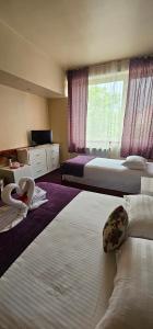 Voodi või voodid majutusasutuse Hotel Olimp toas