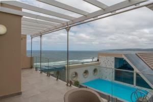 a balcony with a view of the ocean at Views Boutique Hotel & Spa in Wilderness
