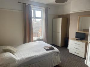 a bedroom with a bed and a window at The Waterside in Redcar