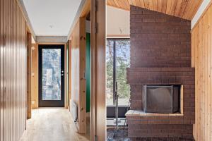 a brick fireplace in the middle of a living room at Sjöutsikt in Södertälje