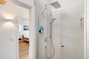 a shower with a glass door in a bathroom at Wolf's Apartment Schwarzwald in Renchen