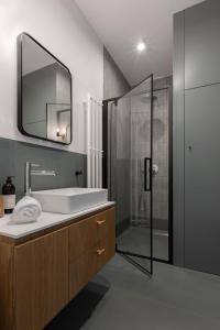 a bathroom with a sink and a shower at Solidarność Three Bedroom & Garden Apartment in Gdańsk