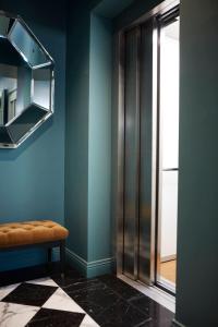 a blue room with a bench and a window at The Townhouse in Udine
