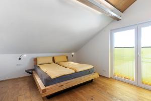 a bedroom with a bed and a large window at Wolf's Apartment Ortenau in Renchen