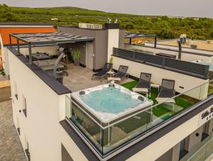 an overhead view of a building with a hot tub on the roof at Villa Blue Sky 1 in Turanj