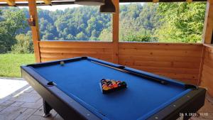 a pool table with a bowl of balls on it at Laganini Country in Samobor