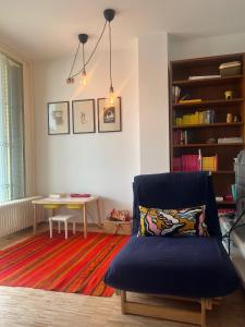 a living room with a chair and a table at la casa della luce in Verona