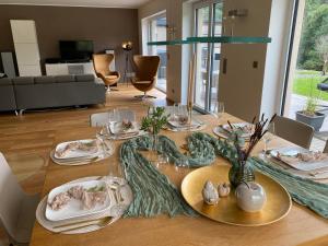 a dining room table with plates of food on it at Eifel-Mosel-Hideaway in Landscheid