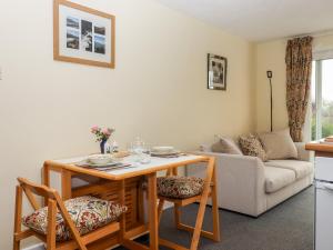 a living room with a table and chairs and a couch at Mabel's View in Totnes