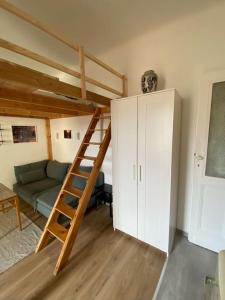 a living room with a bunk bed and a couch at Charming apartment in the heart of Gellért area. in Budapest